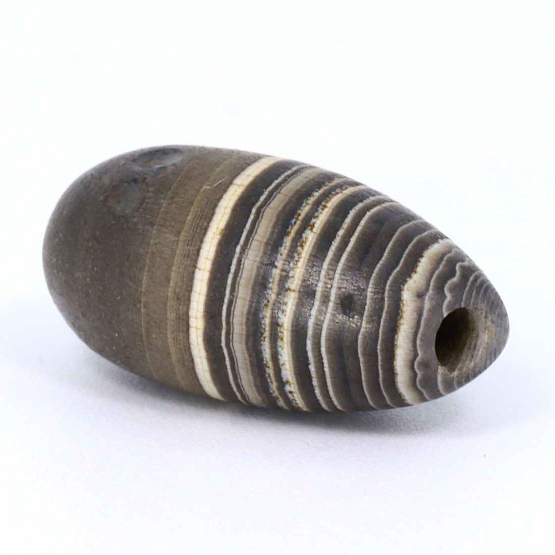 Ancient Sulemani Banded Agate Dzi Bead: Himalayan Elegance (700 BC-500 BC): Dimension: 15x10mm Rarity Level: Highly Rare Sourced from the Himalayan regions of Pakistan, this Sulemani banded agate bead speaks volumes about the artistry of its makers. Its distinctive Dzi patter