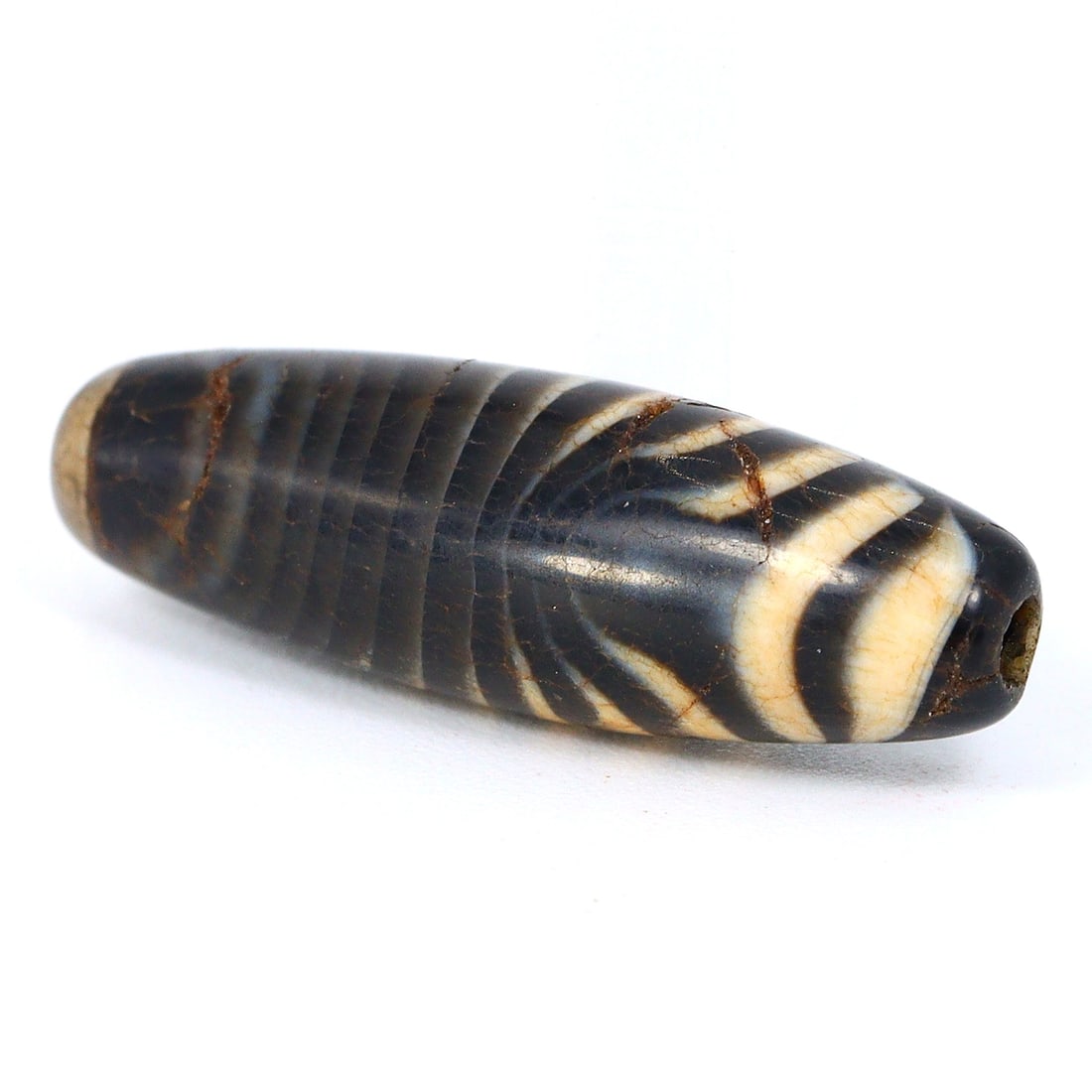 Ancient Sulemani Banded Agate Dzi Bead - Tibetan Silk Road Elegance Unearthed (800-500 BC): Dimension: 20x6 mm Introduction: Embark on a historic journey with this ancient Sulemani banded agate bead, a gem that once traversed the Silk Road between 800 and 500 BC. Meticulously crafted, it enc