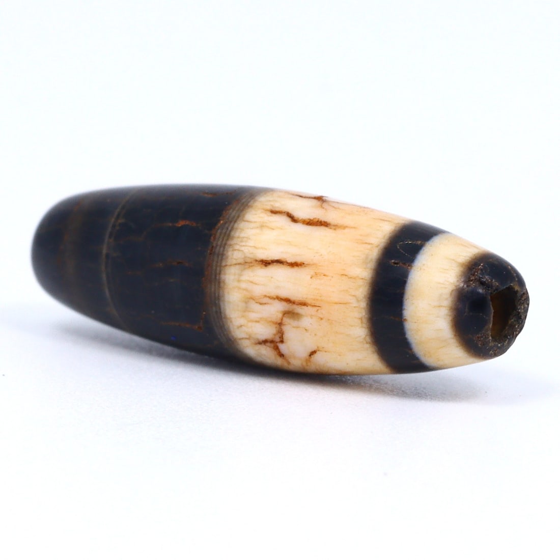 Ancient Sulemani Banded Agate Dzi Bead - Tibetan Silk Road Elegance Unearthed (800-500 BC): Dimension: 20x6 mm Introduction: Embark on a historic journey with this ancient Sulemani banded agate bead, a gem that once traversed the Silk Road between 800 and 500 BC. Meticulously crafted, it enc