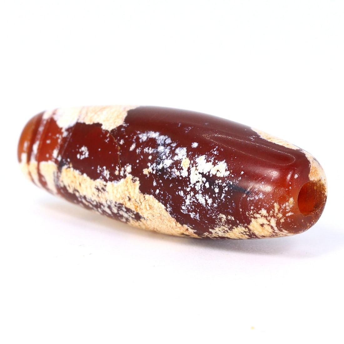 Captivating Greco-Bactrian Kingdom Carnelian Bead of Affluence (3rdC BC-2ndC BC): Dimension: 28x10mm Introduction: Step into the illustrious past of the Greco-Bactrian Kingdom with this alluring carnelian bead, a luxury from the 3rd to 2nd century BC. Meticulously shaped and polish