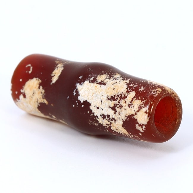 Captivating Greco-Bactrian Kingdom Carnelian Bead of Affluence (3rdC BC-2ndC BC): Dimension: 28.8x11.2mm Introduction: Step into the illustrious past of the Greco-Bactrian Kingdom with this alluring carnelian bead, a luxury from the 3rd to 2nd century BC. Meticulously shaped and po