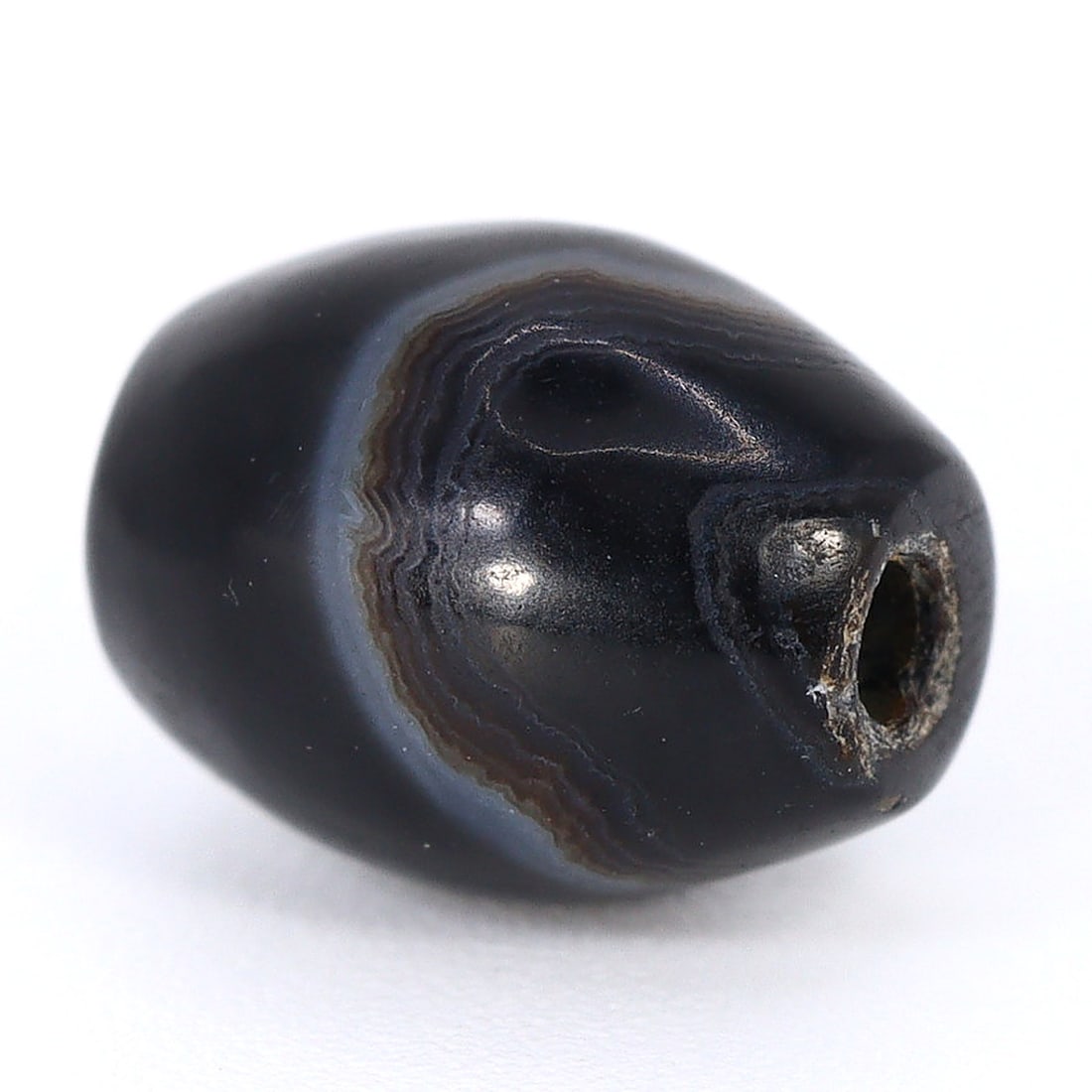 Ancient Tibetan Chung Dzi Bead: Emblem of Himalayan Mastery (800-500BC): Dimension: 8x6mm Rarity Level: Extremely Rare Attributed to ancient Tibetan craftsmanship, this Dzi bead carries with it the legends and spirituality of the Himalayan region. It is not merely a bead, 