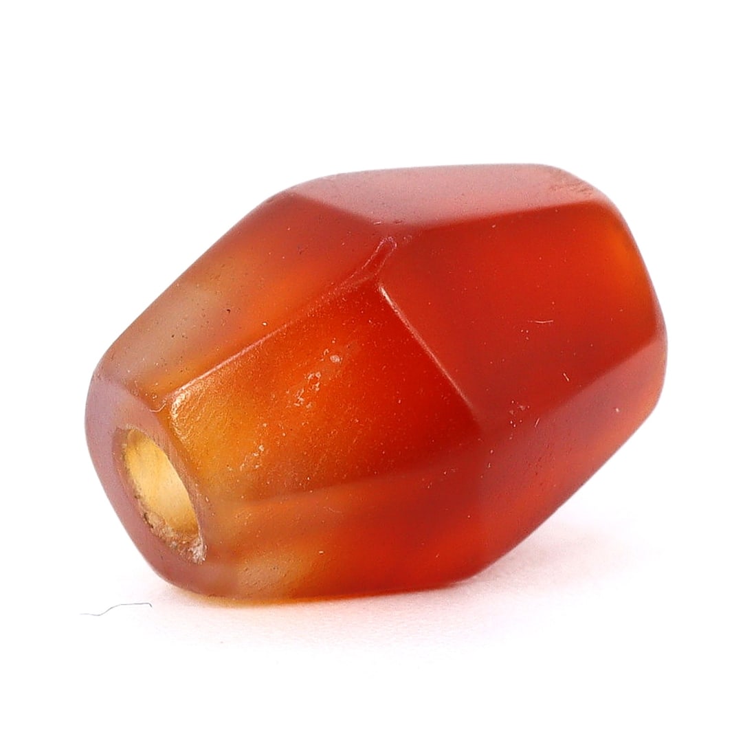 Exquisite Islamic Era Carnelian Facet Bead Intricate Craftsmanship (800-1200 AD): Dimension: 12.8x10mm Introduction: Immerse yourself in the rich tapestry of Islamic history with this stunning carnelian bead from the era of the Islamic Empires, precisely between 800 and 1200 AD. Th