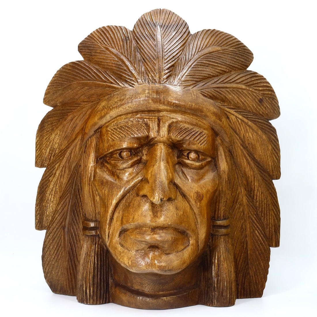 Hand-Carved Indigenous Chief Mask in a Stoic Expression: A Tribute in Timber: Dimension: 30x25cm Weight: 1259gram Introduction: Evoking the dignified power of Indigenous leaders, this hand-carved wooden mask captures the profound expressiveness and resilience emblematic of nati