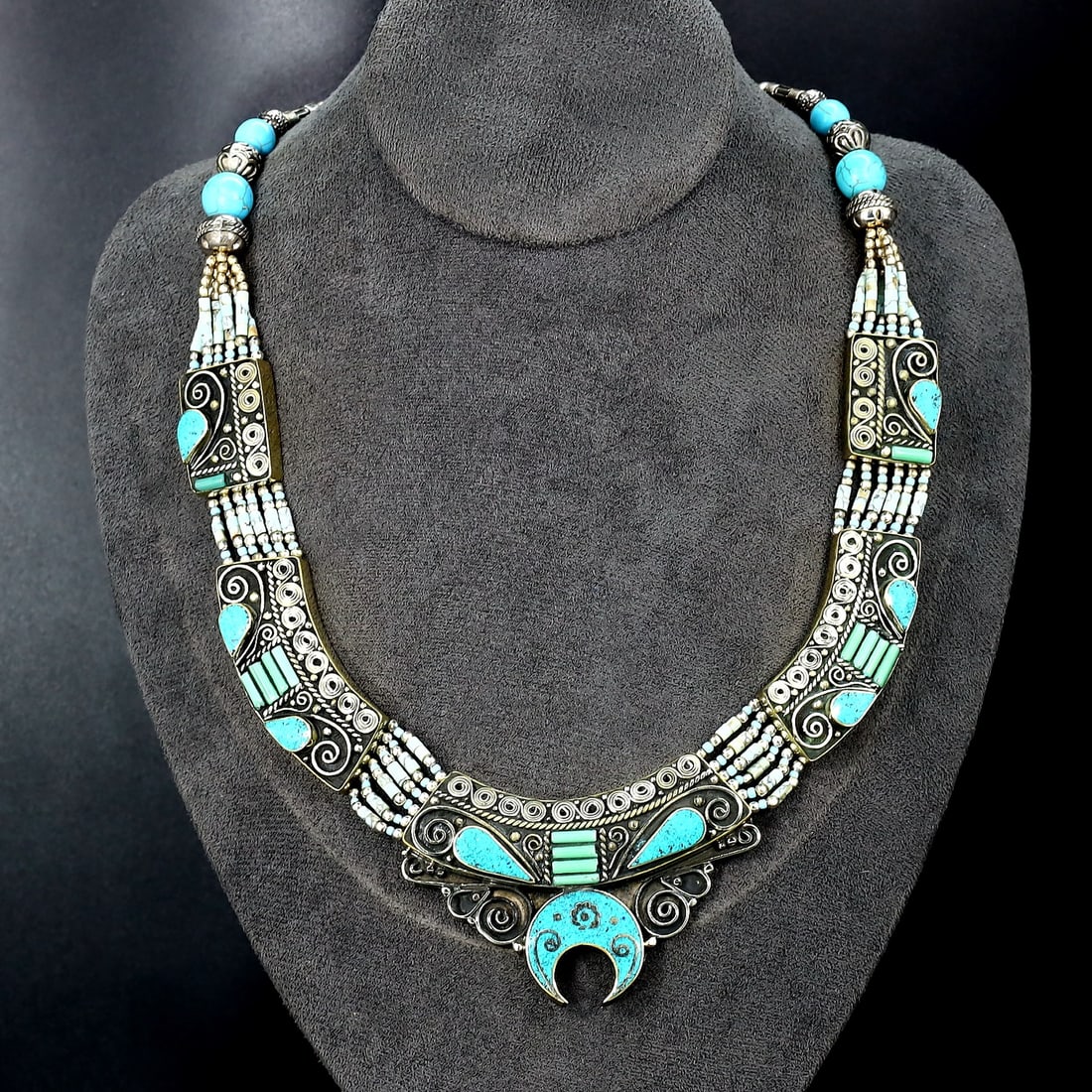 Vintage Tibetan Necklace: An Ode to Tibetan Artistry (Mid-20th Century): Dimension: 18" inches Weight: 140 gram Introduction: Discover a captivating piece of history, the Authentic Vintage Tibetan Pendant adorned with Tribal Silver and Colorful Inlay. This remarkable penda