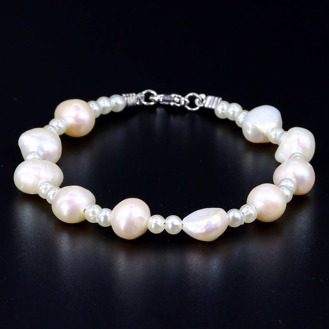 Elegance of Orient: Chinese Cultured Freshwater Pearl Bracelet: Dimension: 8 inches length Introduction: Embodying the delicate allure of Chinese craftsmanship, this cultured freshwater pearl bracelet glows with a serene luster. Its understated elegance is a testa
