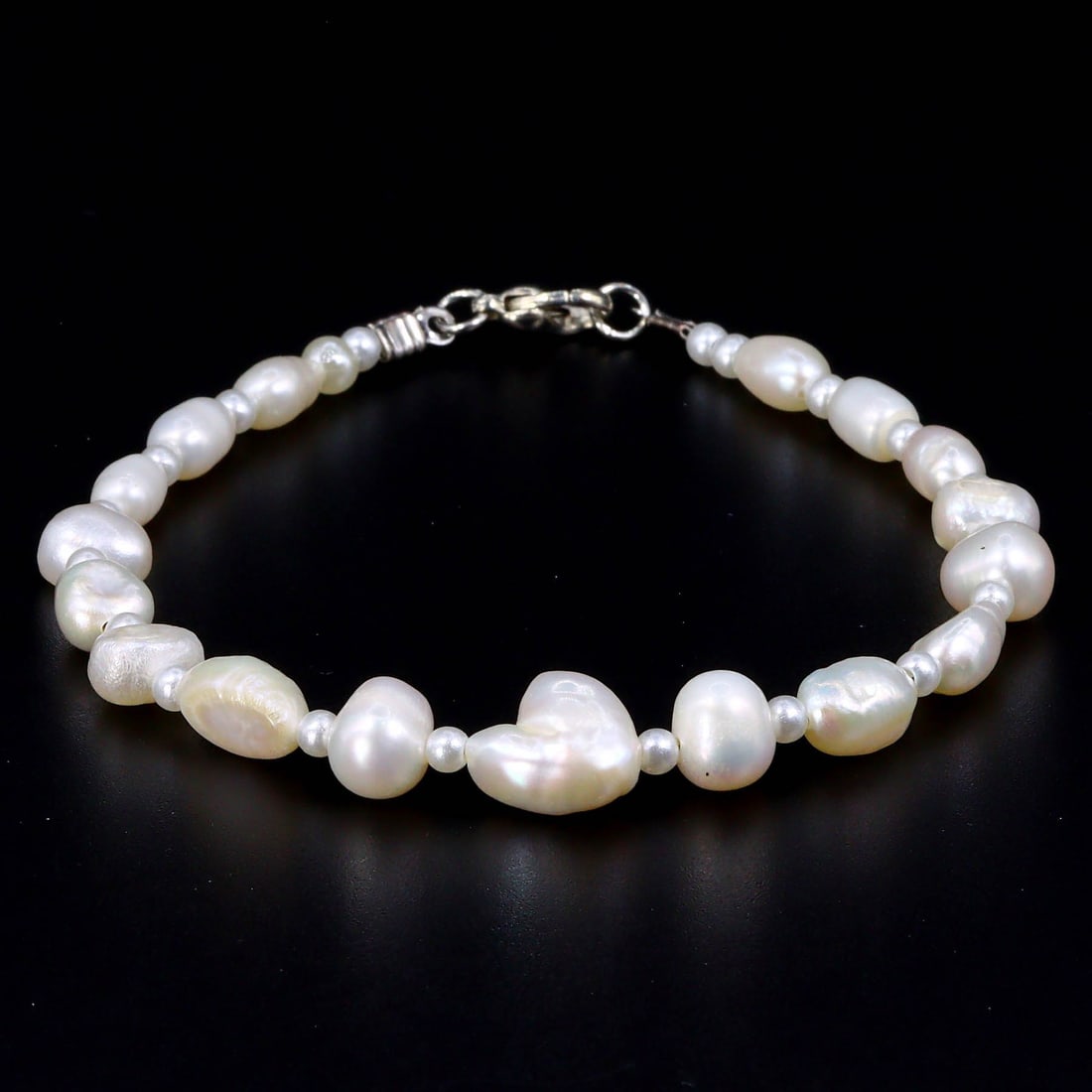 Elegance of Orient: Chinese Cultured Freshwater Pearl Bracelet: Dimension: 8 inches length Introduction: Embodying the delicate allure of Chinese craftsmanship, this cultured freshwater pearl bracelet glows with a serene luster. Its understated elegance is a testa