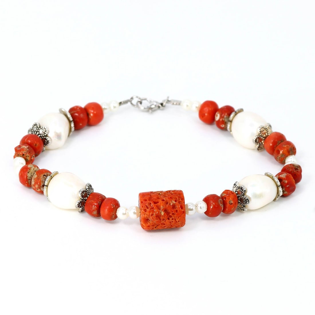 Tibetan Antiquity: Coral Beads and Pearls Bracelet: Dimension: 8"inches Weight: 24 grams Introduction: From the heart of Tibetan tradition comes this bracelet, a relic of bygone times. Antique coral beads, each carrying centuries of history, are interl