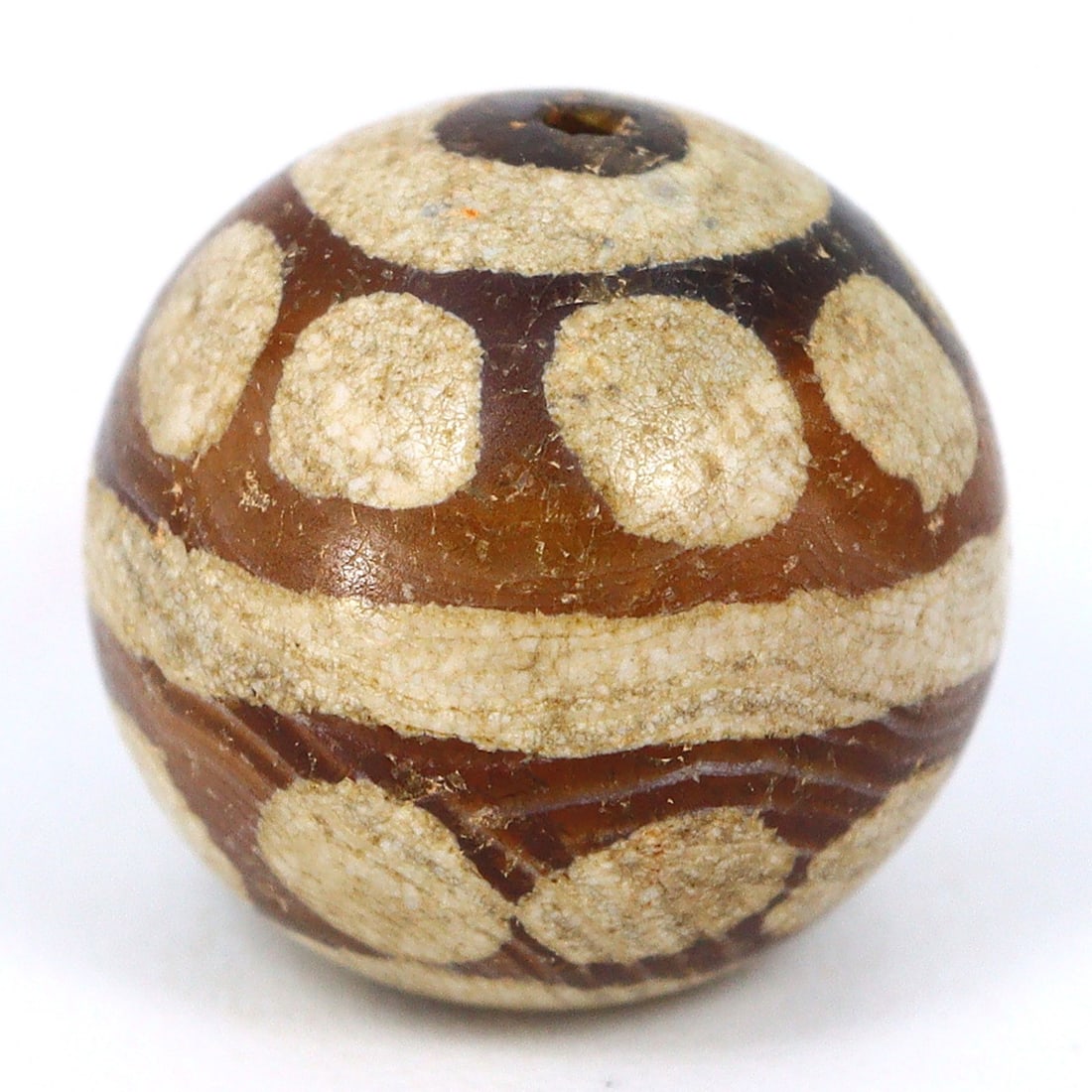 Etched Marvel of Ancient Myanmar: Pyu Carnelian Bead, 2nd Century BCE - 9th Century CE: Dimension: 9.5x9mm Rarity Level: Highly Rare This bead, stemming from the Pyu era, represents a unique piece of history from an ancient civilization that existed nearly two millennia ago. Estimate: $2