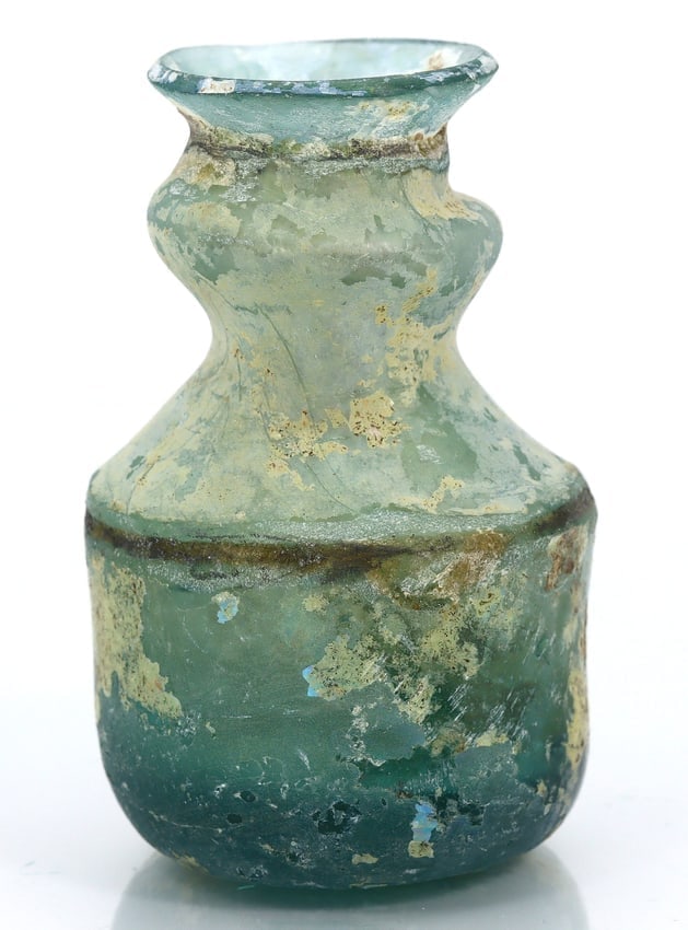 Ancient Roman Glass Flask: A Glimpse into the Roman Empire (27 BC-476 AD): Dimension: 73mm Rarity Level: Very Rare Given its roots in the illustrious Roman Empire and the advanced glassmaking techniques of the time, this flask stands as a testament to a rich historical perio