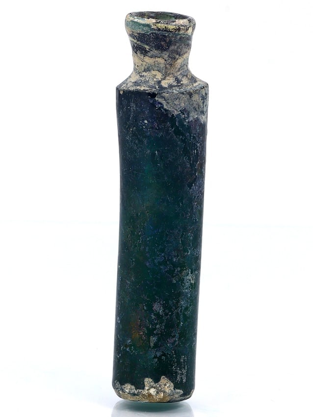 Ancient Roman Glass Flask: A Glimpse into the Roman Empire (27 BC-476 AD): Dimension: 85mm Rarity Level: Very Rare Given its roots in the illustrious Roman Empire and the advanced glassmaking techniques of the time, this flask stands as a testament to a rich historical perio