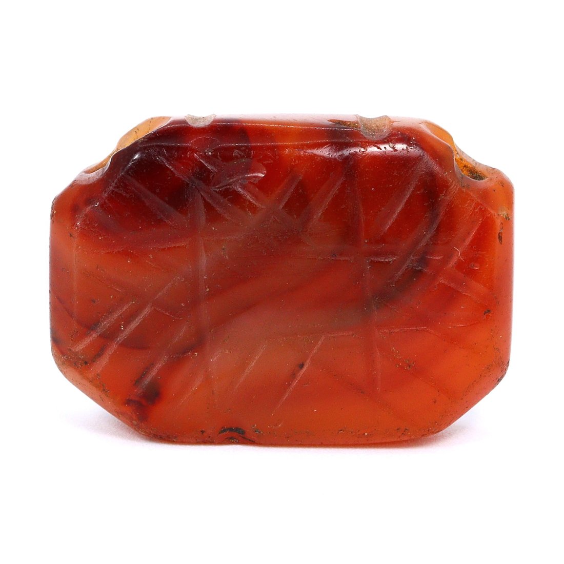 Sassanid Empire Engraved Carnelian Bead with Linear Markings (224-651 AD): Dimension: 25x18mm Introduction: Immerse yourself in the legacy of the Sassanid Empire with this ancient carnelian bead, adorned with precise linear markings, dating from 224 to 651 AD. This gemstone 