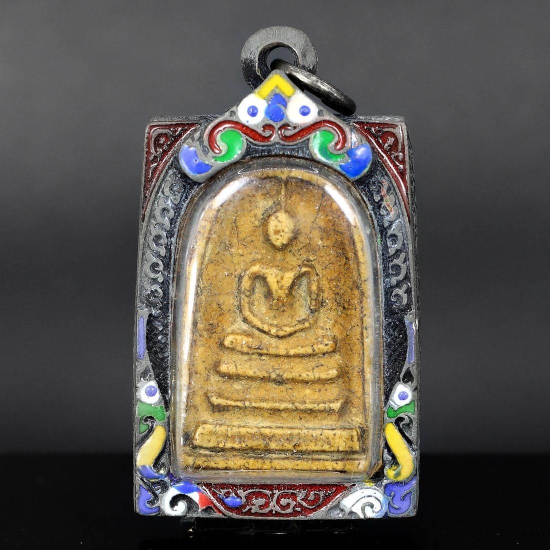 Antique Southeast Asian Buddha Amulet in Vintage Thai Casing (circa early 20th Century): Dimension: 60x30mm Rarity Level: Highly Rare Given its antique grade and the distinctiveness of the vintage Thai casing, this Buddha amulet is a unique representation of Southeast Asian spiritual art 
