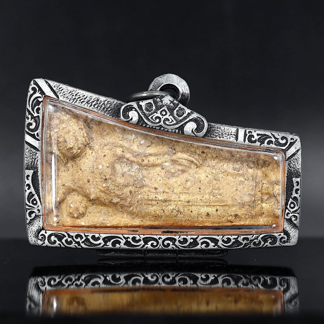 Antique Southeast Asian Buddha Amulet in Vintage Thai Casing (circa early 20th Century): Dimension: 60x35mm Rarity Level: Highly Rare Given its antique grade and the distinctiveness of the vintage Thai casing, this Buddha amulet is a unique representation of Southeast Asian spiritual art 