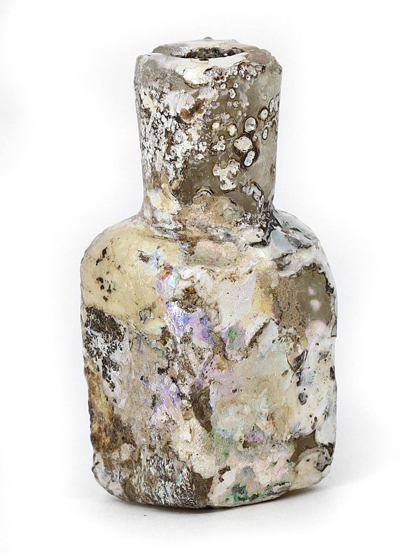 Ancient Roman Glass Unguentarium, 1st-3rd Century AD: This Roman glass unguentarium, standing at a height of 5 cm (1.97 inches) and width of 2 cm (0.79 inches), is a small bottle commonly used to hold precious oils and perfumes in antiquity. Its iridesce