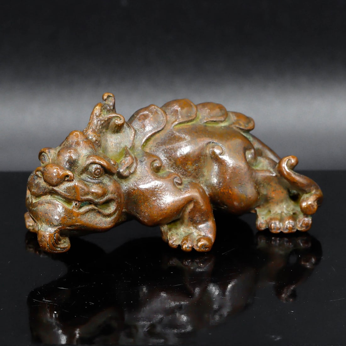 Chinese Han Dynasty Style Mythical Beast Bronze Sculpture: The striking bronze/brass sculpture measures 7.5x3 cm (approximately 2.95x1.18 inches), depicting a mythical beast that evokes the grandeur of the Han Dynasty's art. The creature's form, with its robu