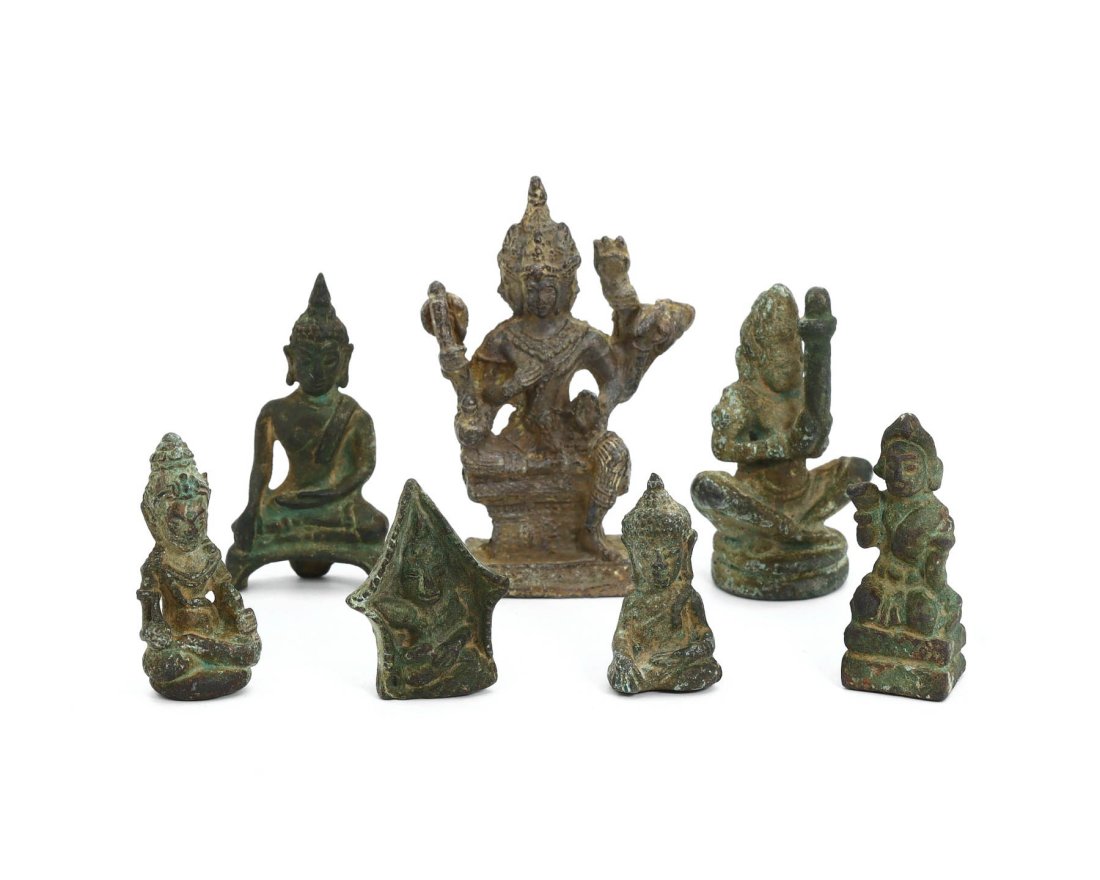 Group of 7 Tibetan & Southeast Asian Antique Bronze Deities: This collection is a remarkable ensemble of seven antique idol sculptures, each cast in bronze or brass, with the tallest standing at 7 cm by 5 cm, which translates to about 2.76 inches in height and