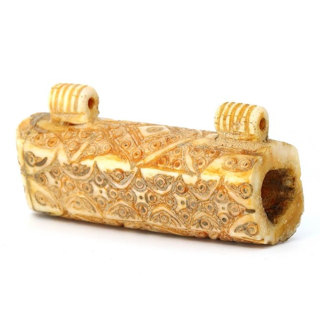 Coptic Byzantine Bone Amulet Holder with Detailed Carving (6th-7th Century AD): This exquisite Coptic Byzantine amulet holder, dimensions 6.5x3 cm or 2.56x1.18 inches, is a remarkable artifact crafted from either bone or ivory. It showcases the meticulous artistry of the era with