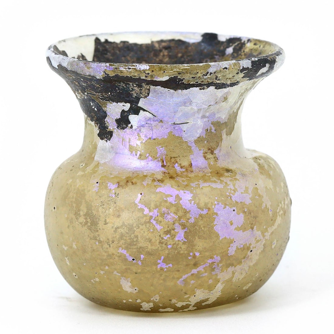 Roman Iridescent Glass Jar with Everted Rim (c. 1st-2nd Century AD): At 4 cm in height, 3.5 cm in width, and 3 cm in depth (about 1.57 x 1.38 x 1.18 inches), this Roman glass jar is a captivating piece of ancient art. Its rounded body, short neck, and pronounced everte