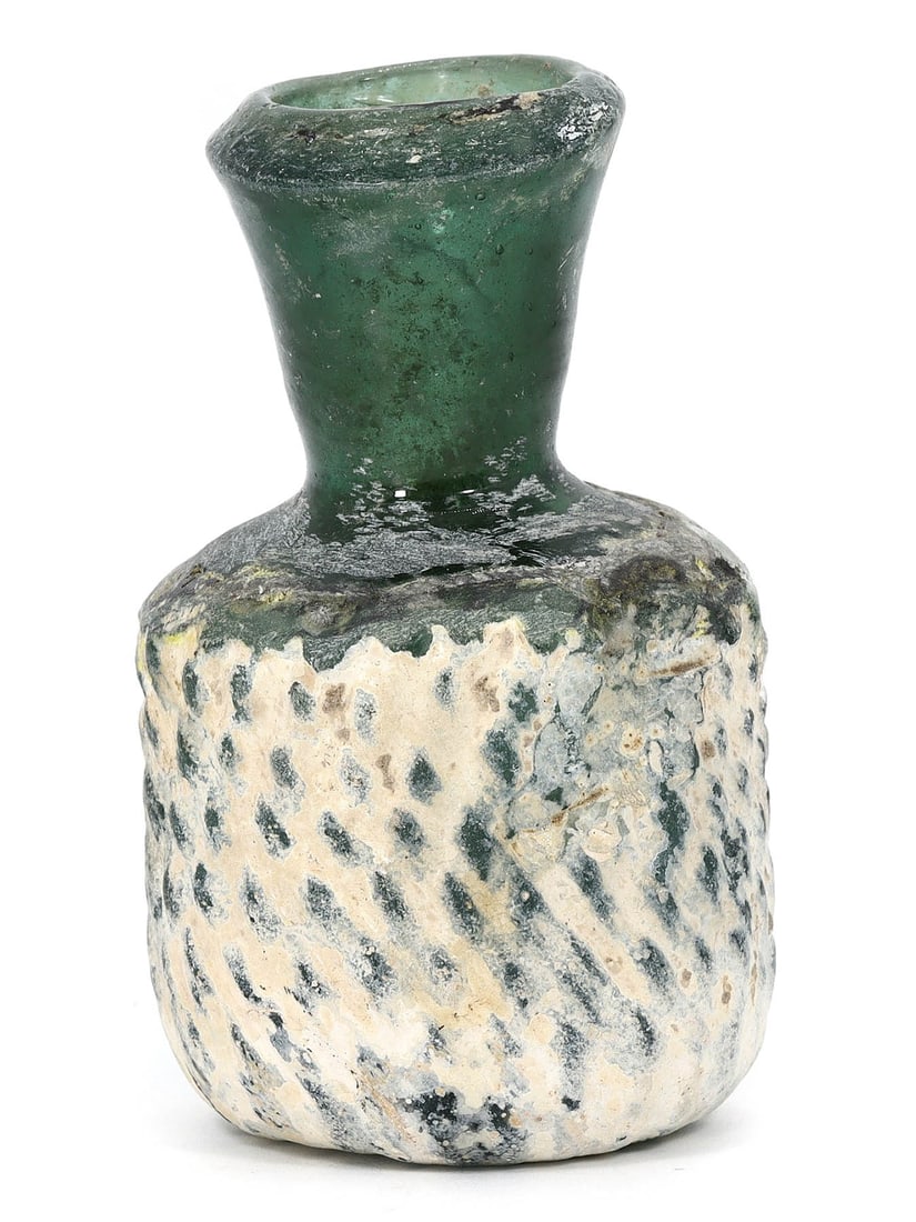 Roman-Byzantine Glass Vessel/Bottle (1st-7th Century AD): This exquisite glass vessel, dating back to the Roman-Byzantine era spanning the 1st to 7th century AD, is a testament to the ancient artistry of glassmaking. Measuring 8x5x4.5cm, it showcases the ski
