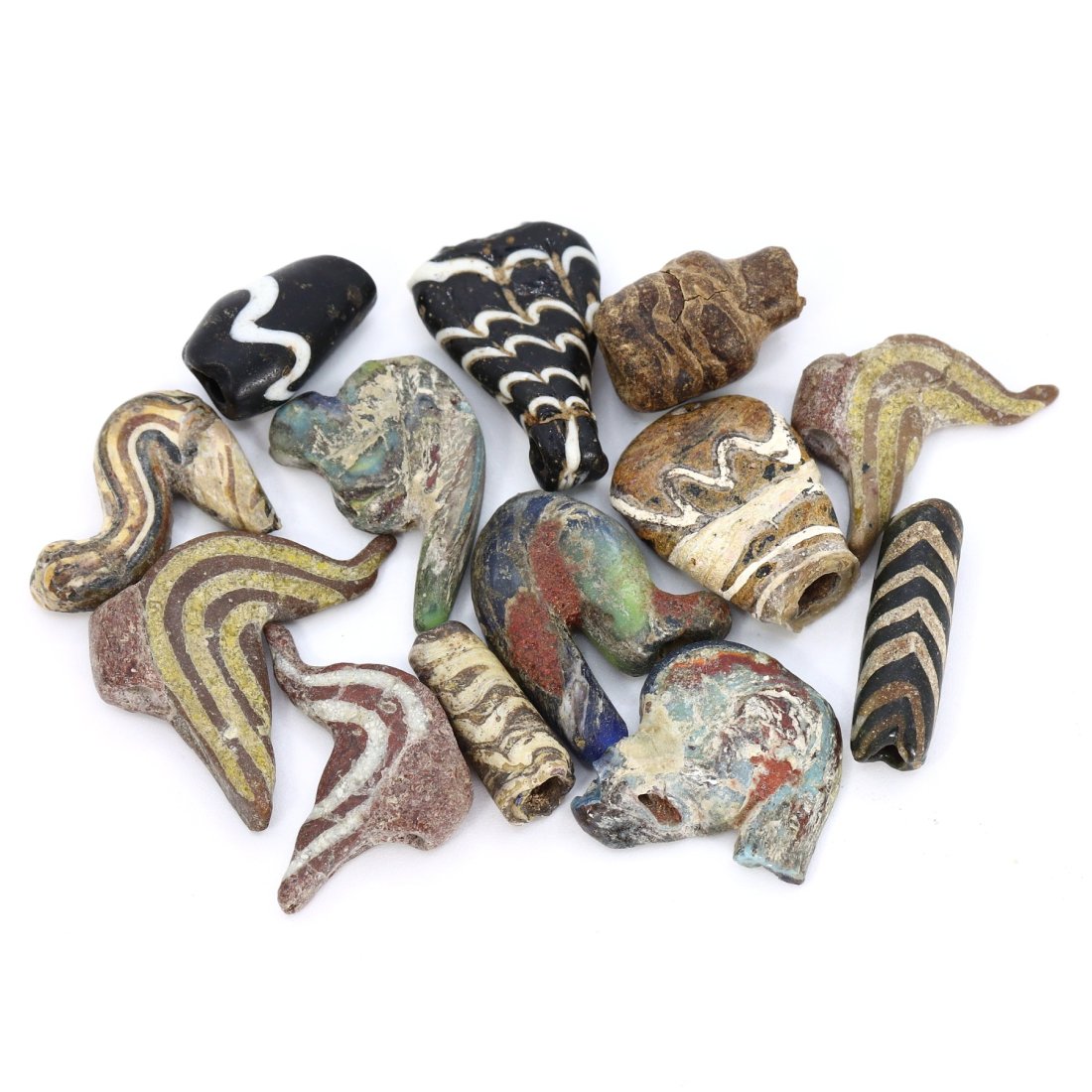 Byzantine-Egyptian and Islamic Era Glass Amulet Collection (4th-19th Century AD): This remarkable collection of 13 ancient amulets spans across two distinct eras and cultures, the Byzantine-Egyptian and Islamic eras. Dating from the 4th to the 19th century AD, these glass amulets v