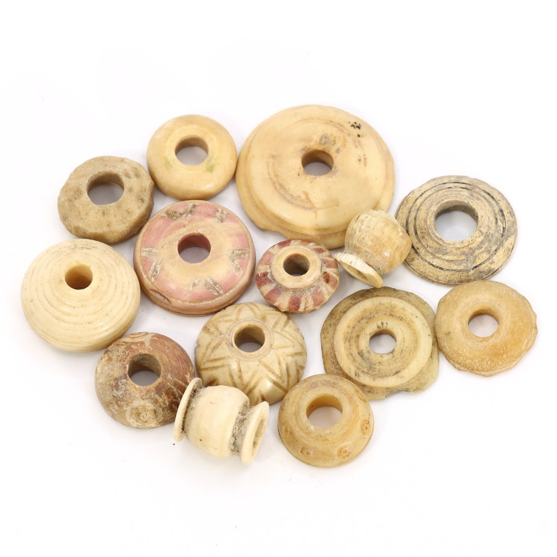 Nishapur Bone Spindle Whorl Collection (9th–10th Century): This lot includes a group of 14 spindle whorls, dating from the 9th to the 10th century, excavated in Nishapur, Iran. These artifacts vary in size, ranging from 4 to 13 mm in diameter, approximately 0