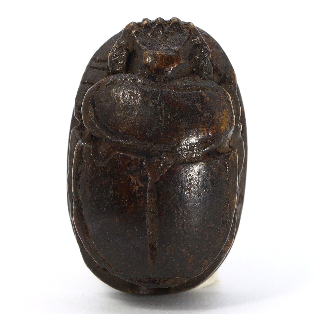 Egyptian Glazed Stone Scarab Seal with Deity Carving (1550-1070 BC): This ancient Egyptian scarab seal, dated to the New Kingdom period, is finely crafted from glazed stone. It has dimensions of 19 mm in length, 12 mm in width, and 9 mm in height, which translates to a