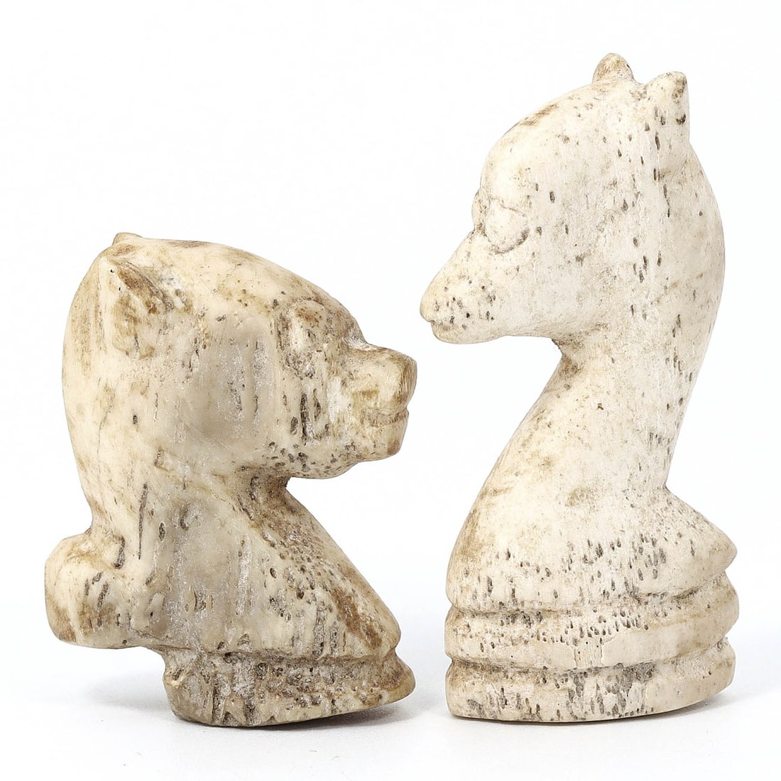 Ancient Roman Ivory Chess Pieces - Two Knights (1st-4th Century AD): These two chess pieces, two knights, stand at 4.5 cm tall and 2.5 cm wide, or approximately 1.77 inches by 0.98 inches. They are sculpted from either ivory or bone, materials commonly used in luxury i