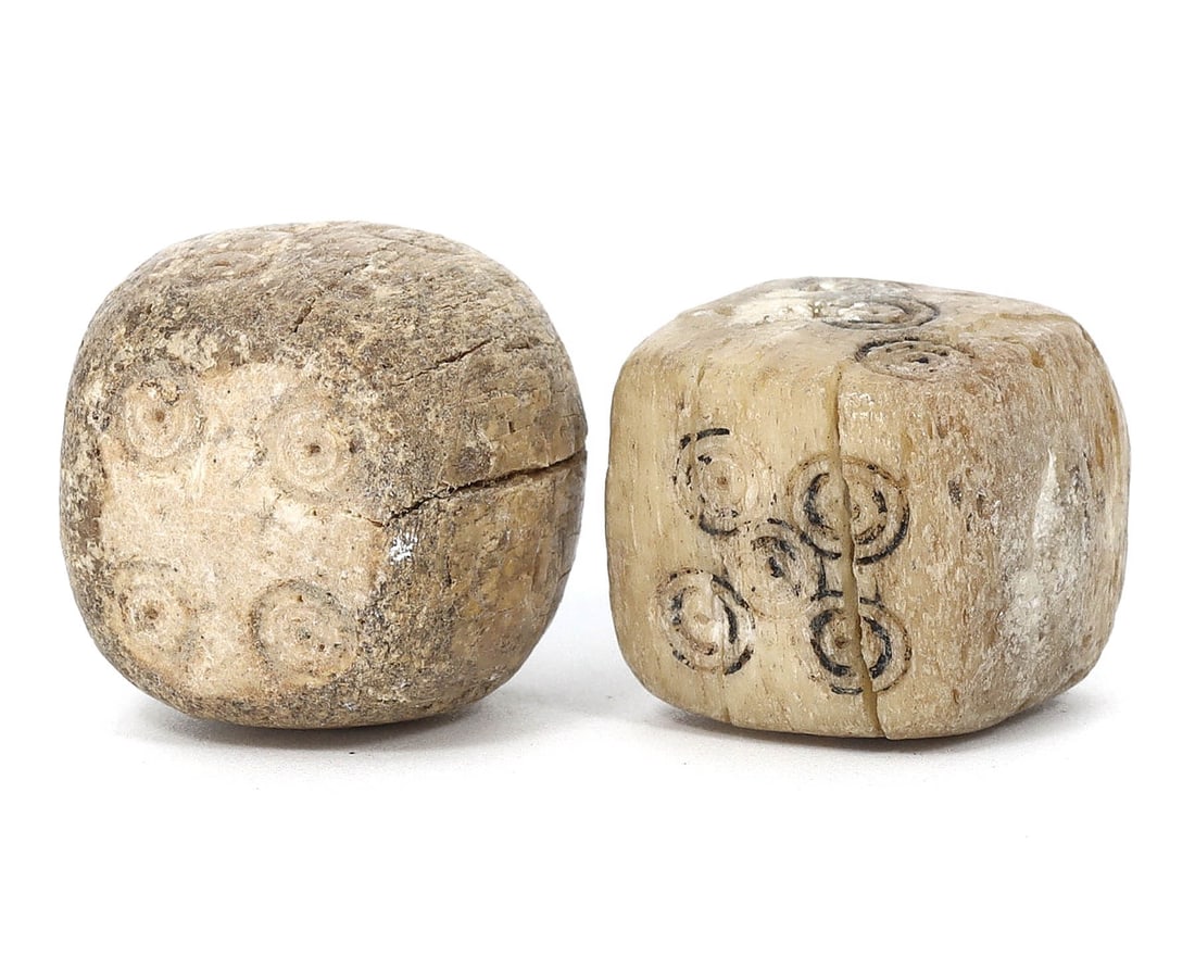 9th-10th Century Iranian Nishapur Bone Dice Pair (800-1000 AD): These exquisite ancient relics are a pair of dice, each measuring 1.5cm in dimension, hailing from the 9th-10th century and excavated in Nishapur, Iran. Crafted from bone, these dice bear intricate in