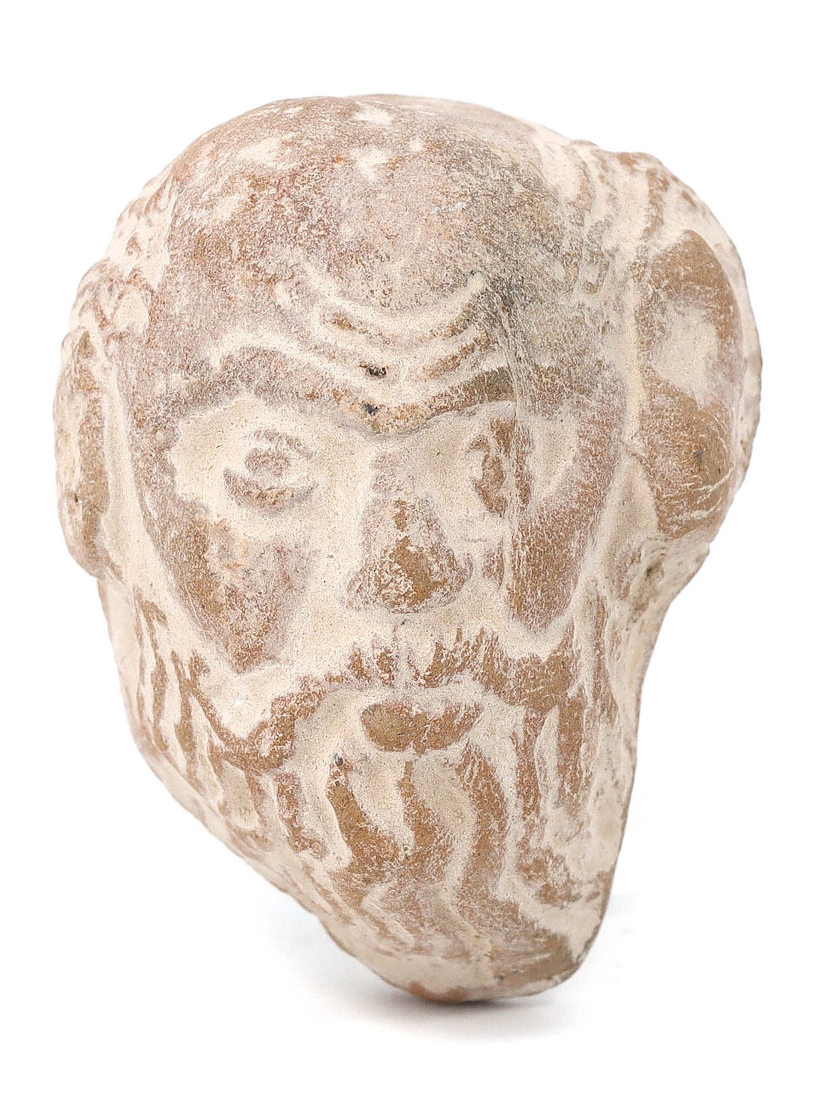 Terracotta Head of an Iranian Nomad - Gandhara, 4th Century: A head believed to depict an Iranian nomad from the ancient region of Gandhara, dating back to the 4th century. This intricately detailed piece measures 4x3x2.5 cm and is a testament to the skilled cr