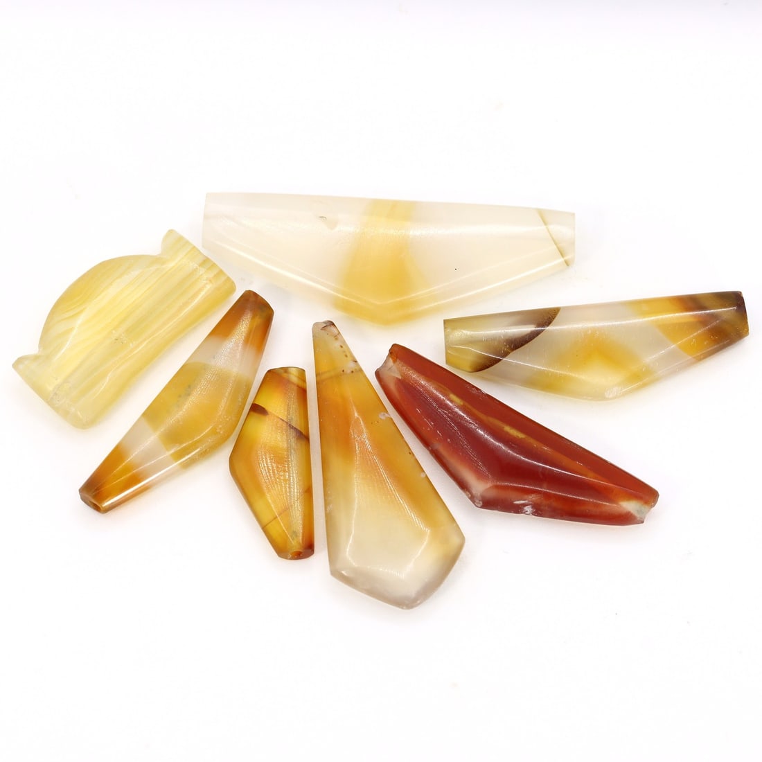 Group of 7 Parthian-Roman Era Ancient Bow Shaped Banded Agate Amulet (1st-3rd Century AD): Approximately 0.8-1.5 inches (20-37 mm), set of 7 pieces. This remarkable collection features seven ancient bow-shaped banded agate amulets, dating back to the Parthian-Roman era, which spanned from t