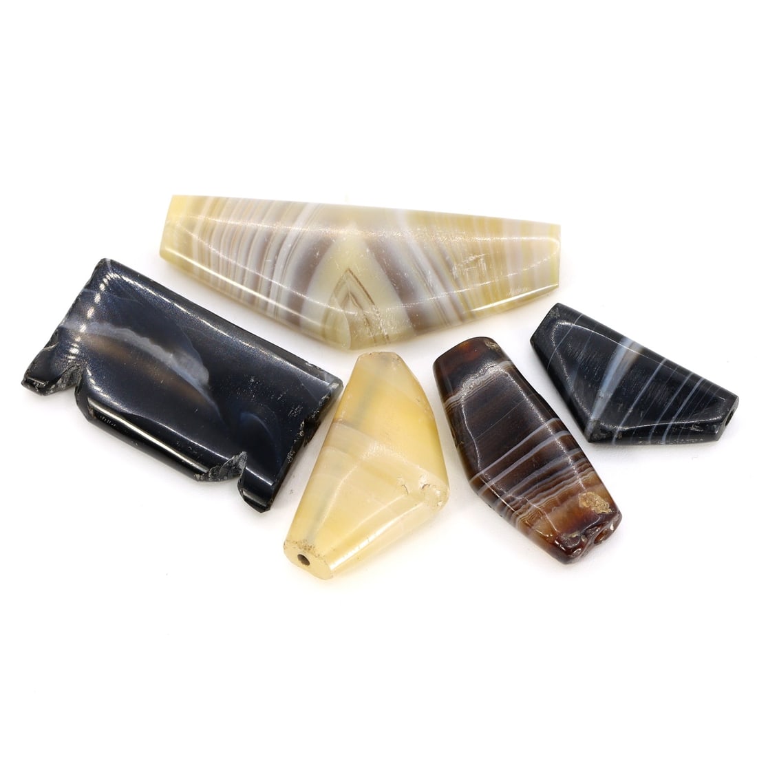 Ancient Persian Banded Agate Bow Shape Amulet Classical Period: These remarkable ancient relics consist of a set of five banded agate amulets, each intricately carved in the shape of a bow. Originating from the ancient Persian era, these amulets showcase the exqui