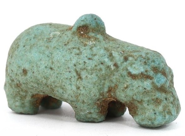 Ancient Egyptian Faience Hippopotamus Amulet (1981-1802 BC): This charming amulet represents a hippopotamus, a creature revered in ancient Egypt, skillfully crafted from faience. It measures 2.5 cm in length, 1.5 cm in width, and 1.3 cm in height, which is abou