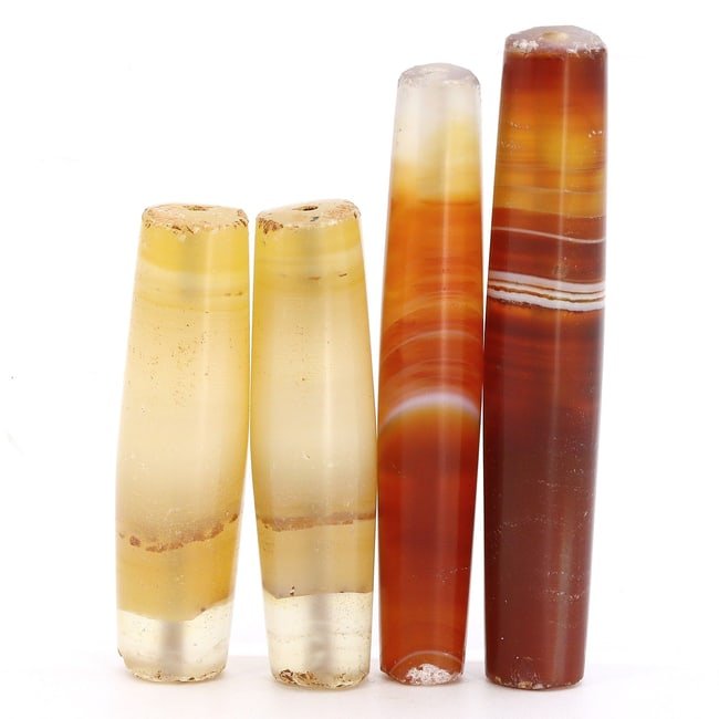 Group of 4 Antique Elongated Himalayan Tibetan Dzi Beads from the Qing Dynasty (17th-19th AD) (1 of 2)