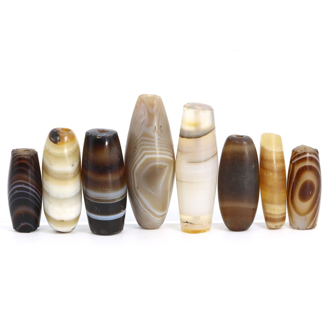 Tibetan Antique Banded Agate Dzi Bead Collection (18th-20th Century AD): Collection of Tibetan antique dzi beads, originating from the 18th to the 20th century AD. This collection consists of 8 exquisite banded agate beads, each with dimensions ranging from 23mm to 38mm. D