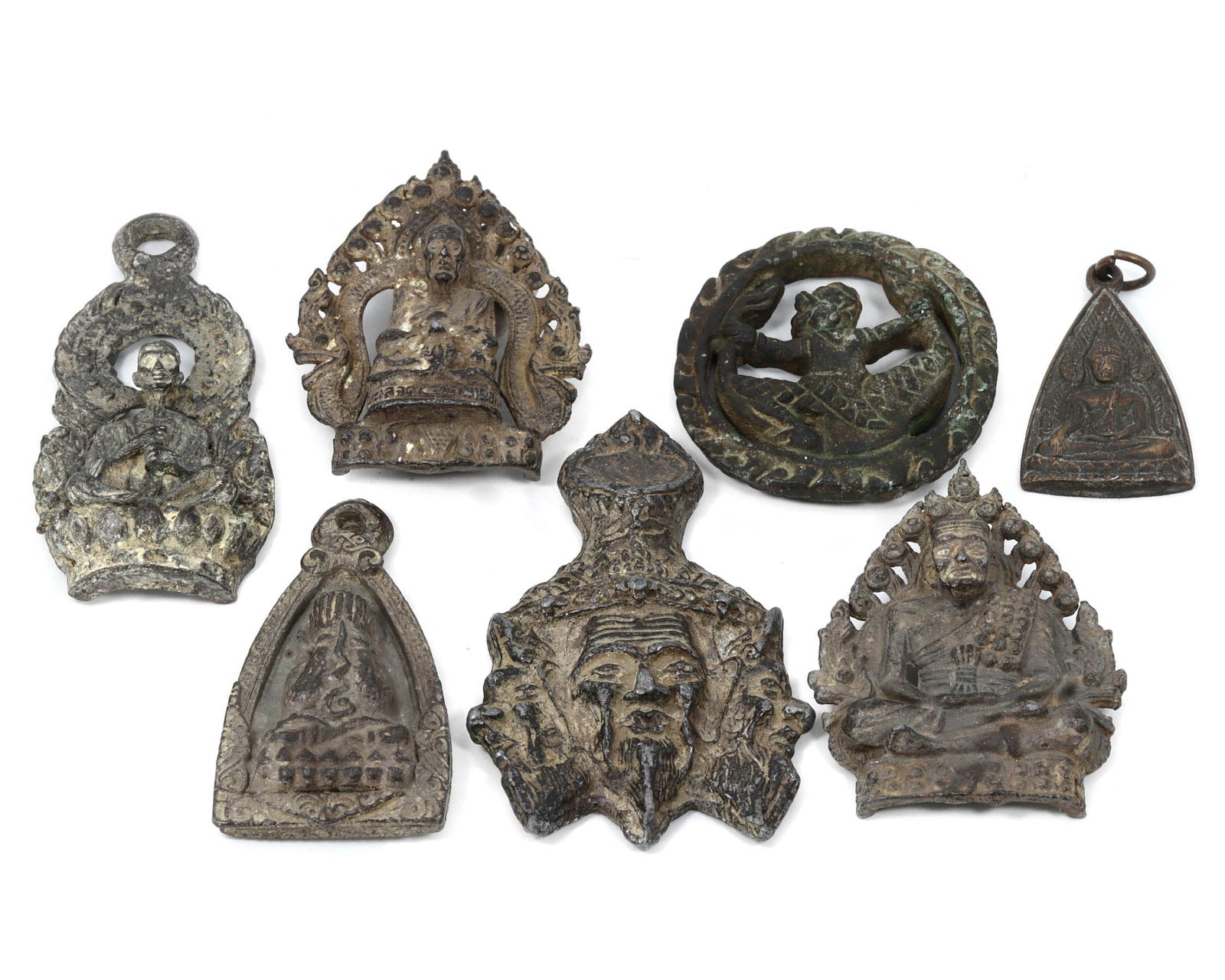 Group of 7 Tibetan & Himalayan Antique Votive Tablet Amulet, 17th-19th AD: This collection of antique votive tablet amulets originates from the Tibetan and Himalayan regions. Crafted from iron and lead, these amulets vary in dimensions, ranging from 3.5 to 6.5 cm each. In th