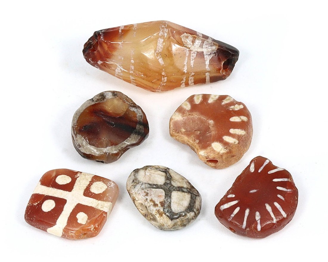 Indo-Himalayan Etched Carnelian Dzi Beads, 1st Millennium BCE - 1st Millennium CE: This compelling lot of six Indo-Himalayan etched carnelian dzi beads, dating back to between the 1st millennium BCE and the 1st millennium CE, showcases the intricate craftsmanship of ancient artisans