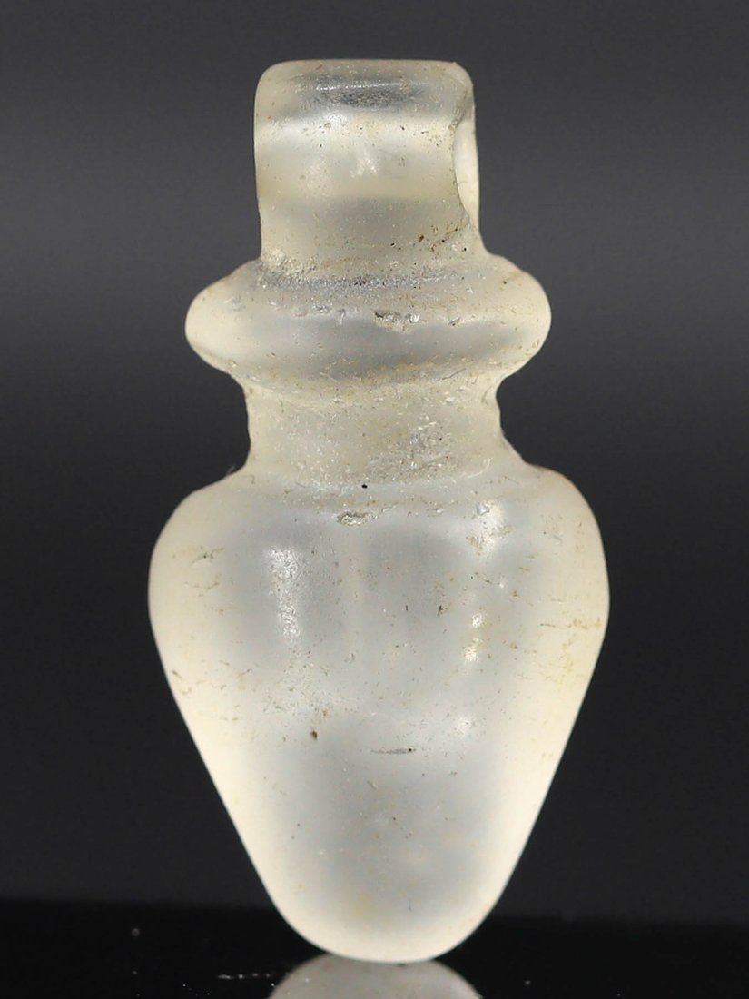 Ancient Egyptian Rock Crystal Heart Amulet, 1300 BC: A meticulously crafted piece, this ancient Egyptian heart amulet measures approximately 2.4x1.2x0.7 cm or 0.94x0.47x0.27 inches. Carved from the purest rock crystal, its translucence symbolizes purity