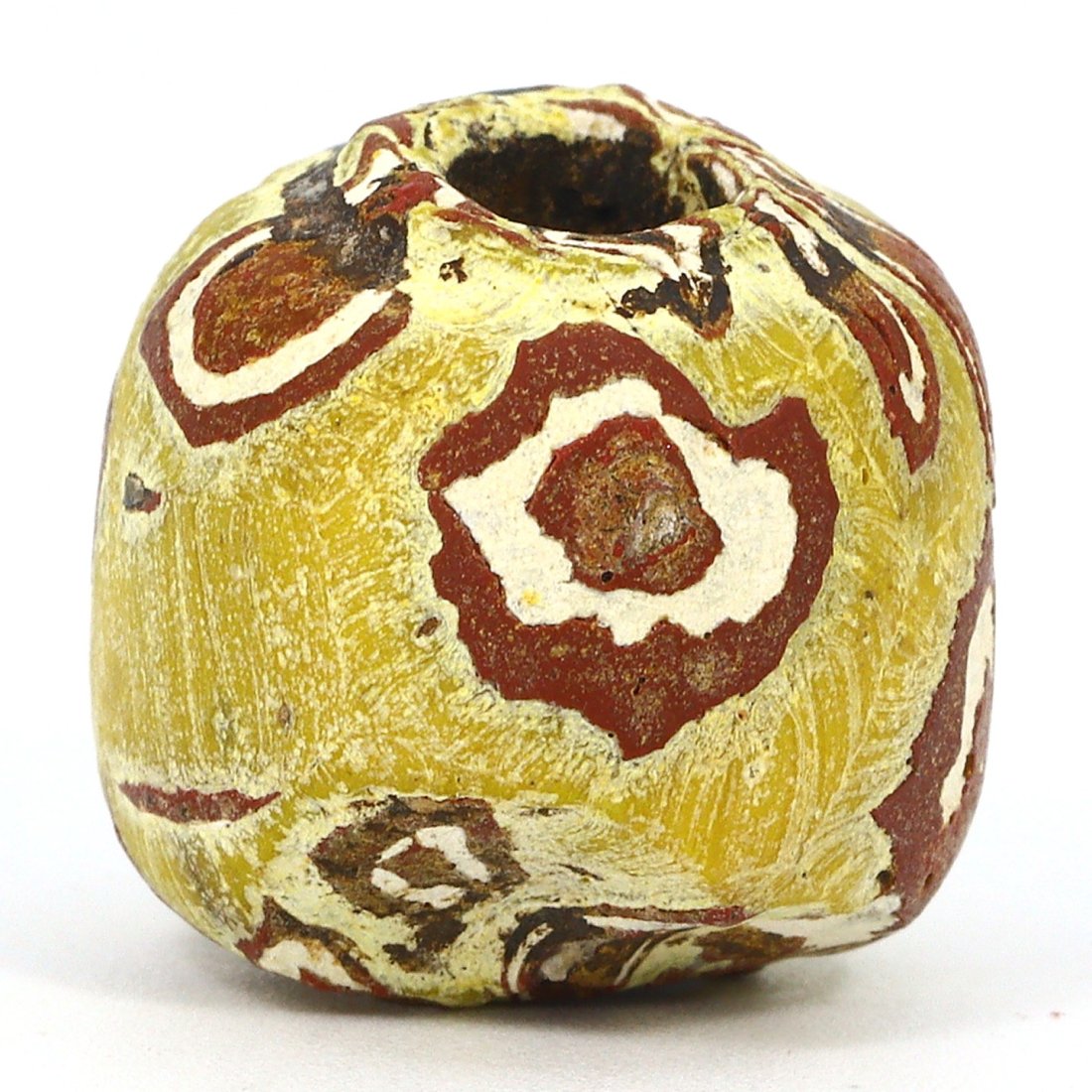 Islamic Period Egyptian Eyed Glass Bead, 9th–15th Century: This solo Islamic Period glass bead from Egypt, dating between the 9th and 15th century, measures 15 mm in diameter. It features the distinctive 'eyed' design, a hallmark of the time, symbolizing vigi