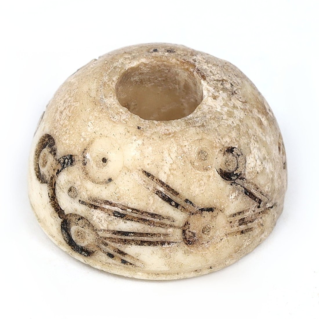 Ancient Persian Bone Spindle Whorl with Incised Design, 9th–10th Century AD: This exquisitely incised bone spindle whorl, unearthed in the historic region of Nishapur, Iran, dates back to the 9th–10th century AD. Measuring 1.6 cm in diameter and 0.9 cm in height, the artifac