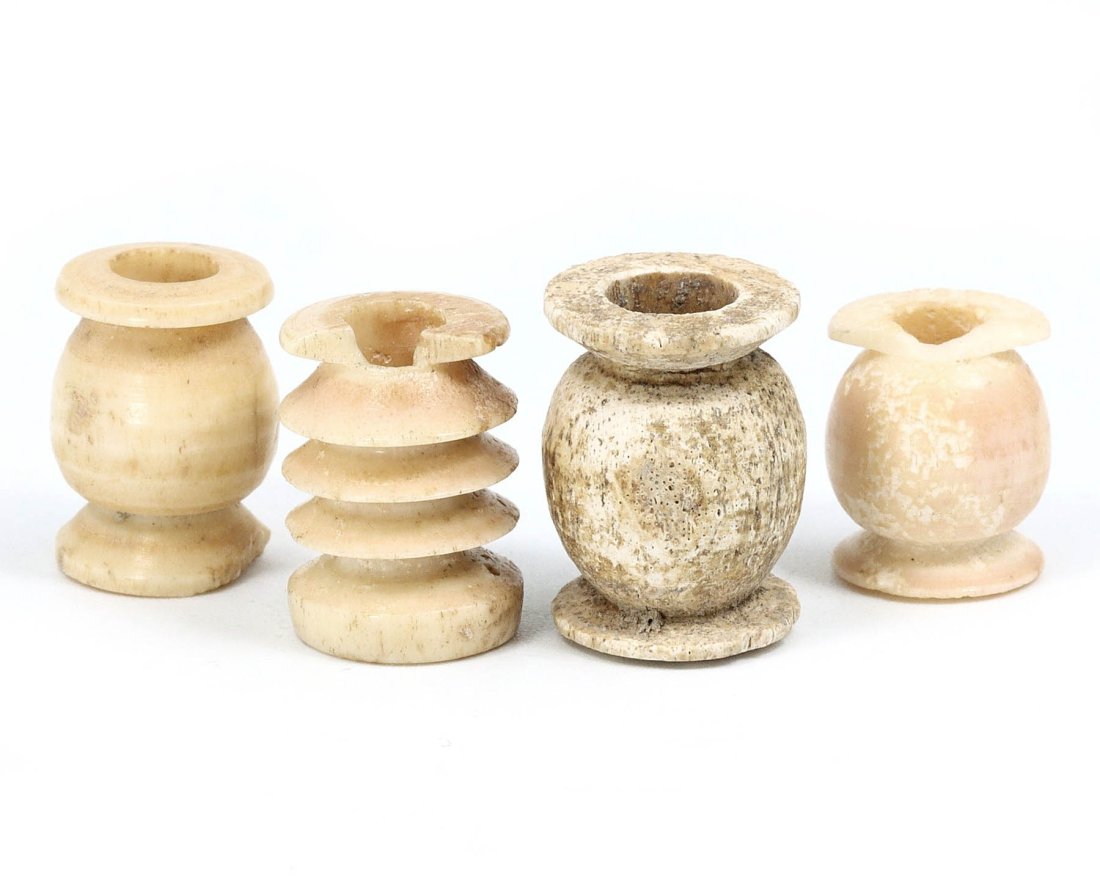 Egyptian Beehive-Shaped Bone Spindle Whorls, 30 BCE–364 CE: This lot features a collection of four beehive-shaped spindle whorls from Egypt, specifically from el-Bahnasa, dated between 30 BCE and 364 CE. Each whorl measures between 1.4 to 1.6 cm, meticulously 