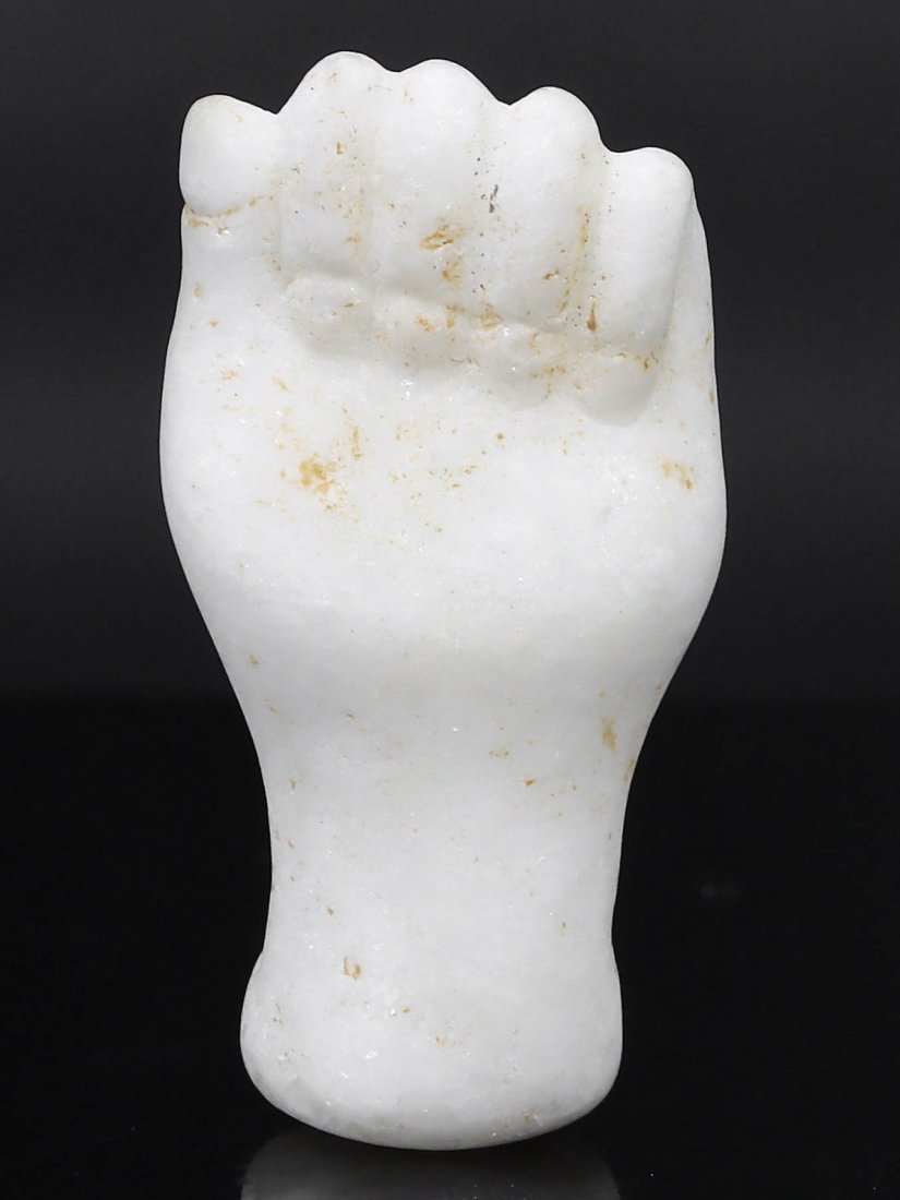 Ancient Egypt Late Period to Ptolemaic Period Marble Fist Amulet, 664–30 B.C.: This marble fist amulet from Egypt's Late Period to the Ptolemaic Period, dating from 664–30 B.C., measures 3.2 cm in height, 1.6 cm in width, and 1.2 cm in depth (approximately 1.26x0.63x0.47 inche