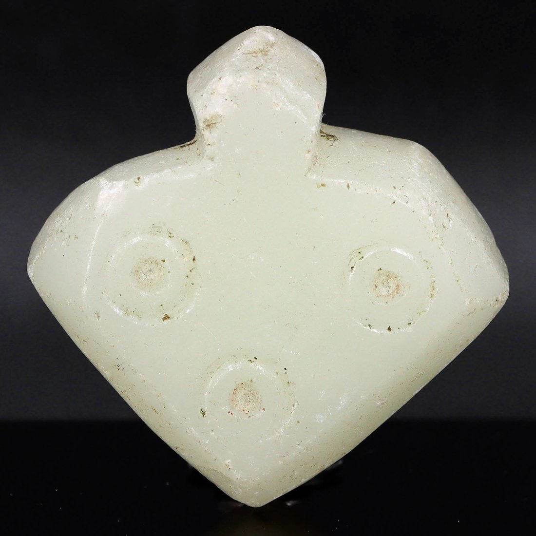 Medieval Marble Triple-Oculus Amulet (12th-15th Century AD): Dimensions: 4x4 cm / 1.57x1.57 inches The triple-oculus motif on this likely marble amulet is evocative of medieval iconography, often used to ward off the evil eye. Such amulets were common in the 12