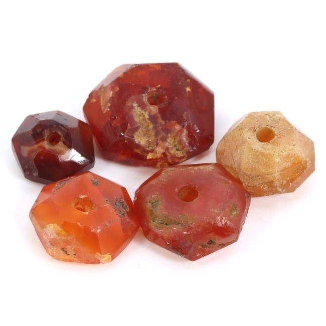 Ancient Harappan Civilization Carnelian Heptagonal Beads, 3300-1300 BC: This lot includes five carnelian heptagonal beads, each ranging in size from 8 to 14 mm (approximately 0.31 to 0.55 inches), reflecting the advanced lapidary techniques of the Harappan civilization. C