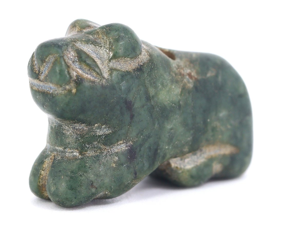 A Verdant Stone Lion Amulet, Late Period, Egypt, 664-332 B.C.: Encapsulating the majesty of the lion, this verdant stone amulet from Egypt's Late Period is a testament to the ancient Egyptians' mastery of symbolism in their art. This miniature sculpture, likely w