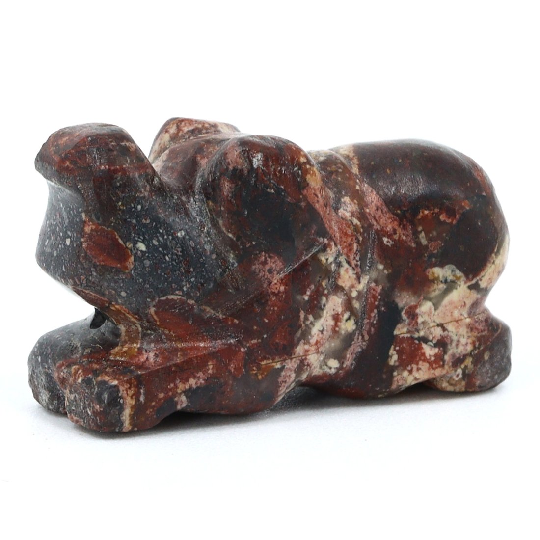 A Pre-Dynastic Egyptian Jasper Elephant Amulet, c. 4000-3000 B.C.: An exquisite jasper elephant amulet from Pre-Dynastic Egypt, this miniature artifact embodies the earliest flourishes of animal symbolism within Egyptian culture. It features a recumbent elephant, its