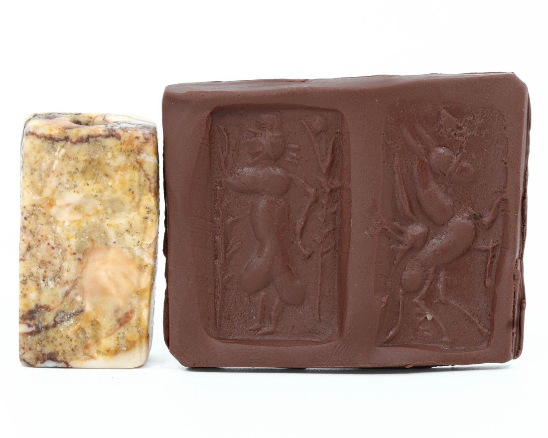 An Egyptian Double Convex Stone Stamp Seal, Pharaonic Period: An exquisite double convex stone stamp seal, hailing from the venerable soil of ancient Egypt. Its surface is adorned with deeply incised hieroglyphic symbols, portraying scenes that may have held rel