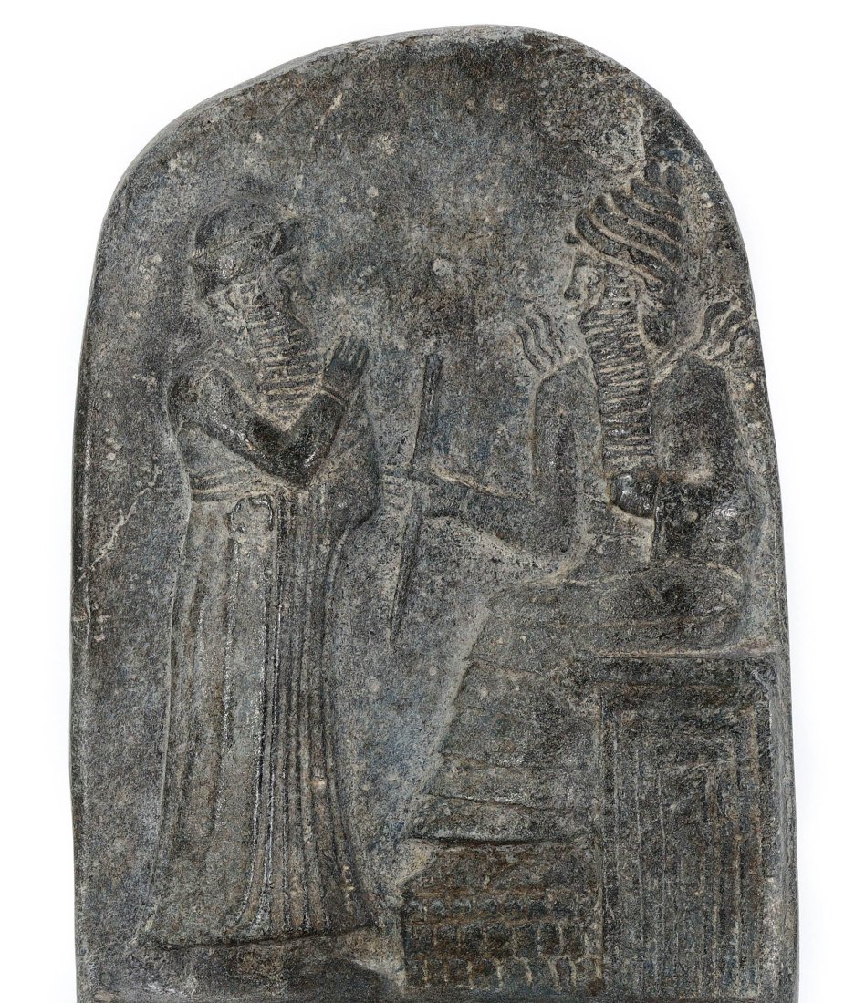 A 20th Century Stone Relief with Mesopotamian Deity Imagery: This compelling stone relief draws inspiration from ancient Mesopotamian iconography, featuring what appears to be a deity in traditional garb, engaging with another figure or an altar. The intricate