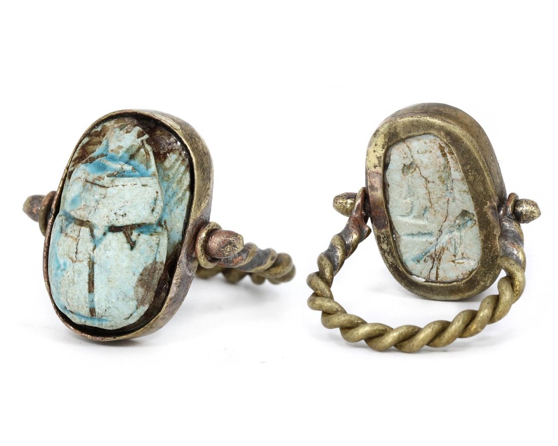 An Ancient Egyptian Steatite Scarab Ring, New Kingdom, 16th–11th Century BC: This exquisitely crafted Egyptian scarab ring, sized US 7, features a steatite scarab that has been glazed, a practice that dates back to the New Kingdom era. The scarab, a symbol of rebirth and regen