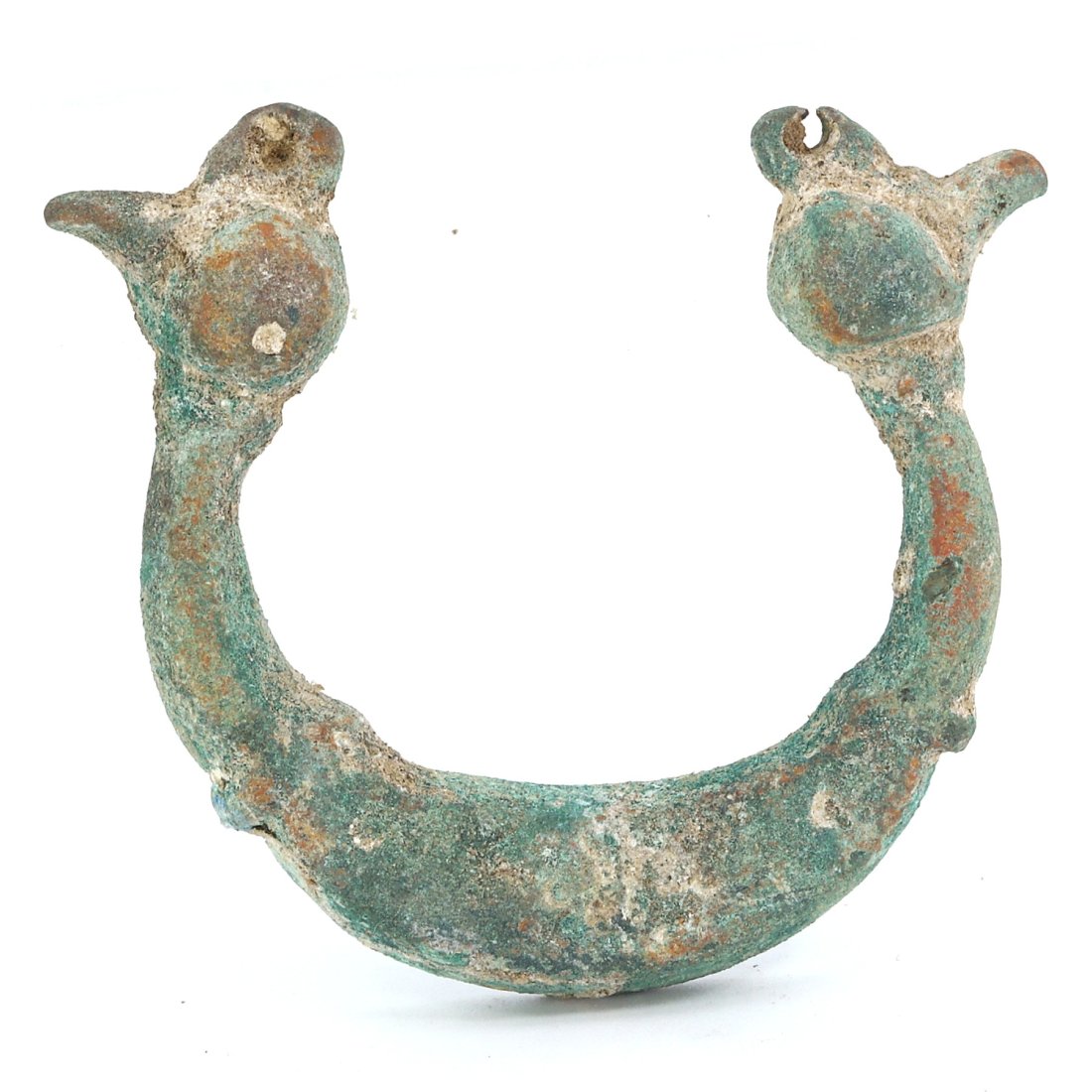 A Luristan Bronze Amulet with Double Cockerel Heads, 1st Millennium B.C.: Hailing from the Iron Age Luristan culture, this evocative bronze amulet is a striking representation of the zoomorphic artistry that flourished in ancient Western Iran. The amulet, with a span of 5 c